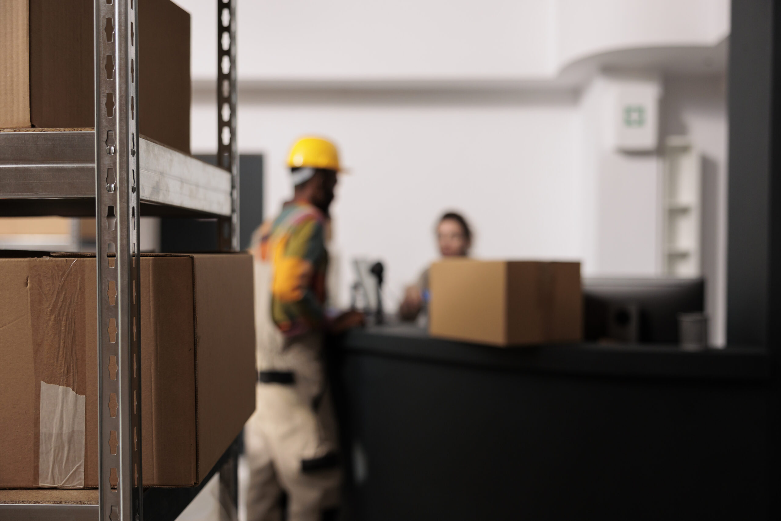selective-focus-metallic-shelves-storage-room-full-with-cardboard-boxes-ready-delivery-background-diverse-team-working-customers-orders-preparing-packages-goods-inventory